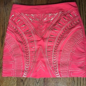 Coral mini skirt with gold accent